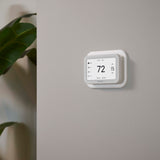 Thermostat Cover Plate Kit White with thermostat installed in room